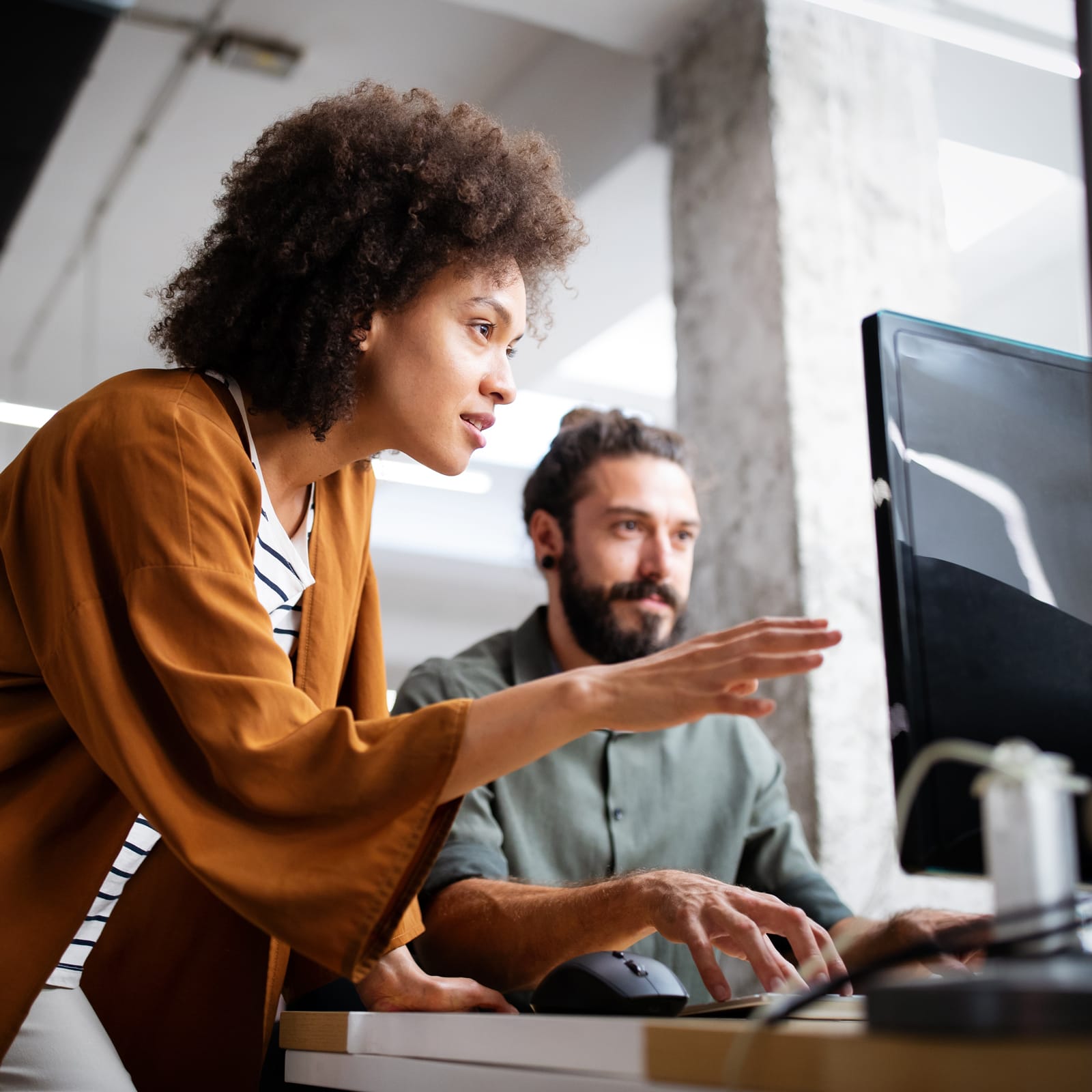 Two people looking at a computer screen