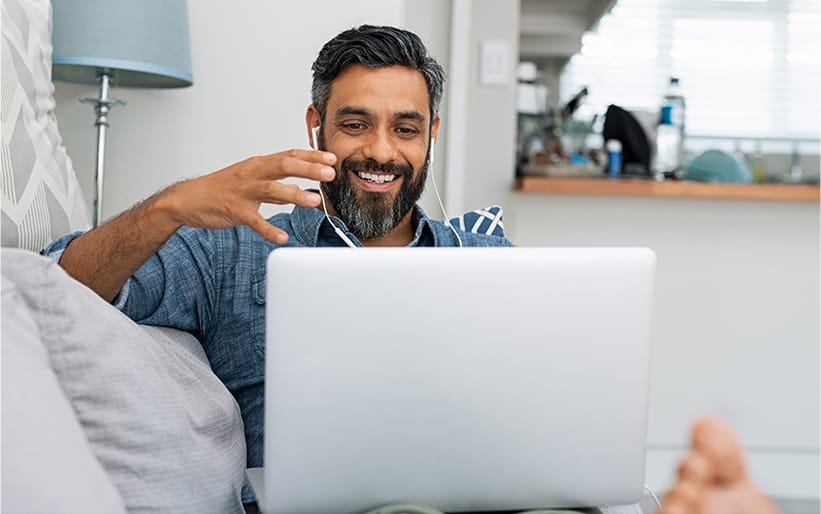 Man on couch looking at laptop